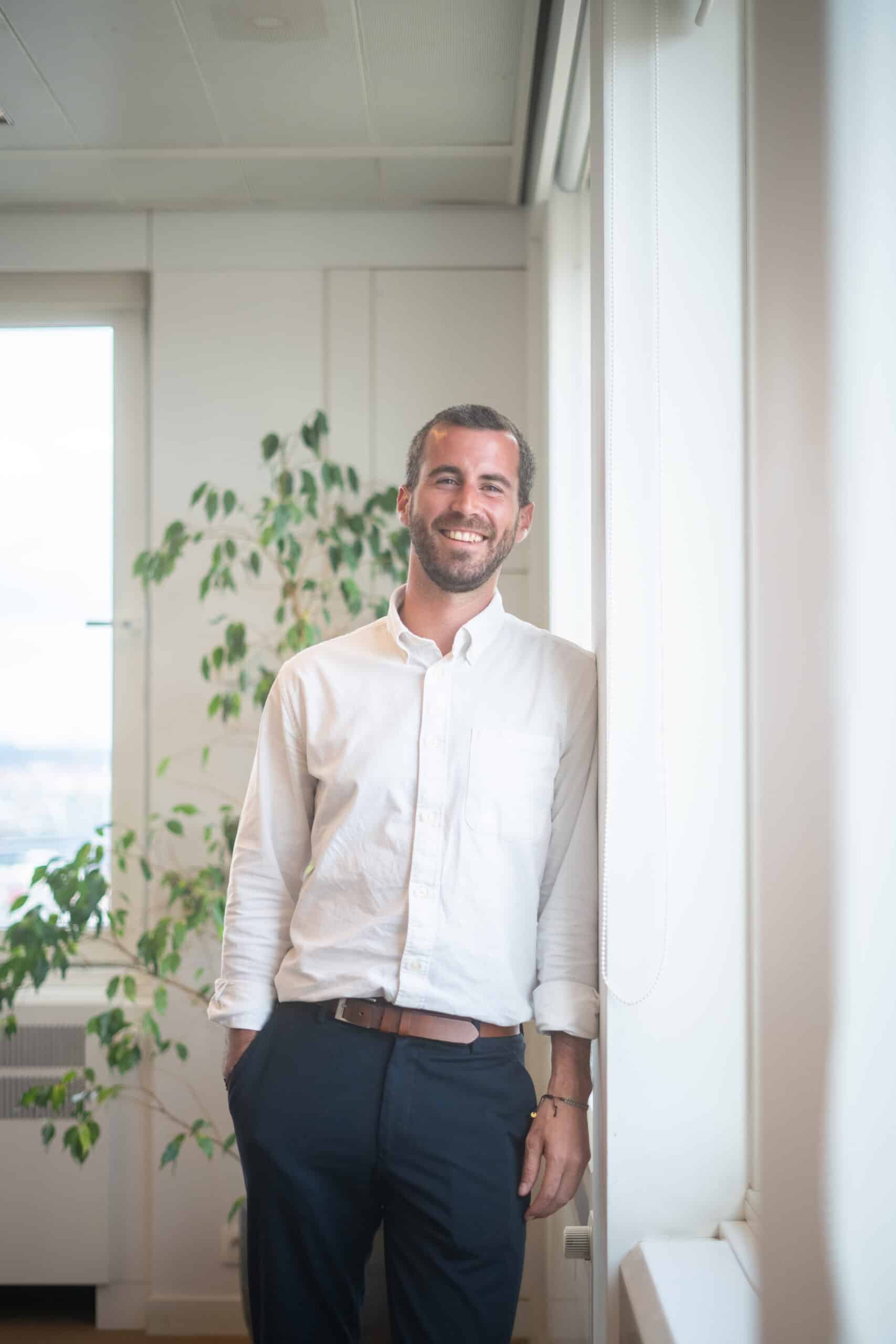 gauthier from dups standing against a wall in the office